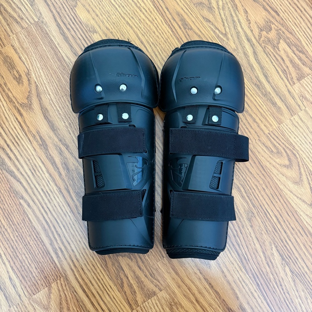 Black Protective Shin Guards with Strap Closure